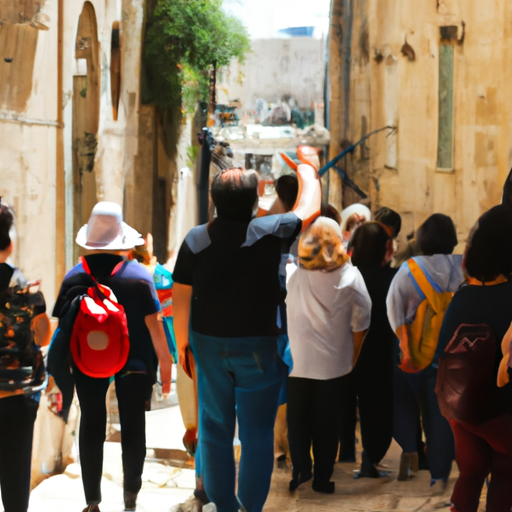 A group of tourists exploring the ancient, narrow streets of Old Jerusalem, guided by a knowledgeable local