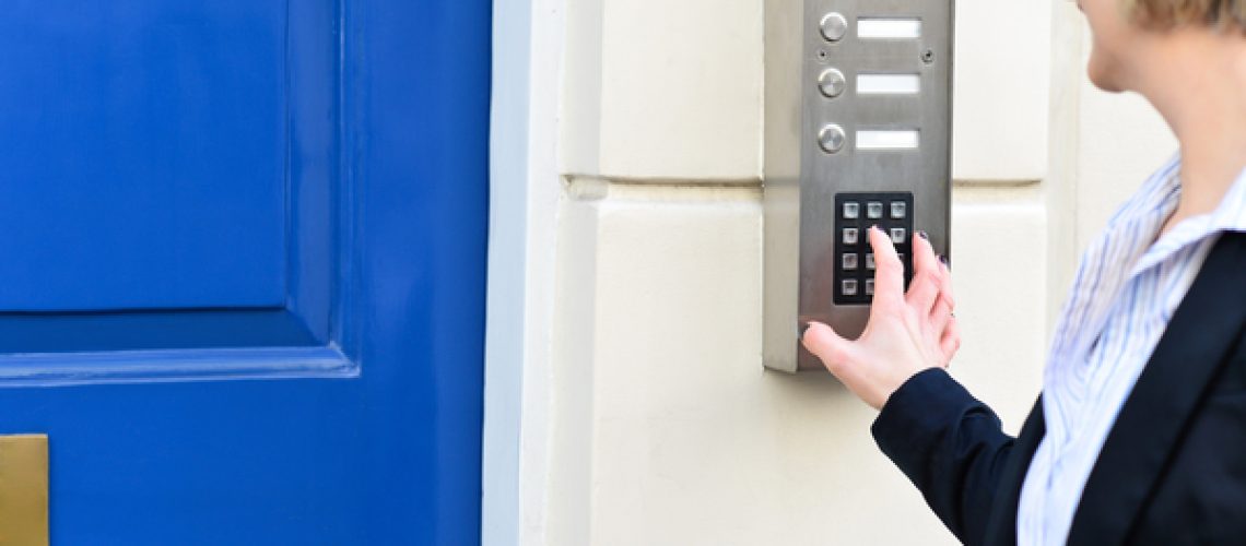 12810194_woman-using-security-system